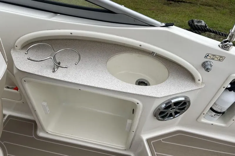 Slide: The Image of Interior of 2015 Stingray 234LR boat with sink, cup holder, and speaker. - 28