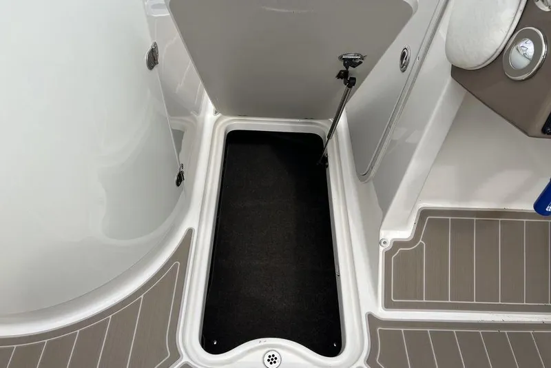 Slide: The Image of Open storage compartment on 2015 Stingray 234LR boat, featuring clean interior design. - 30