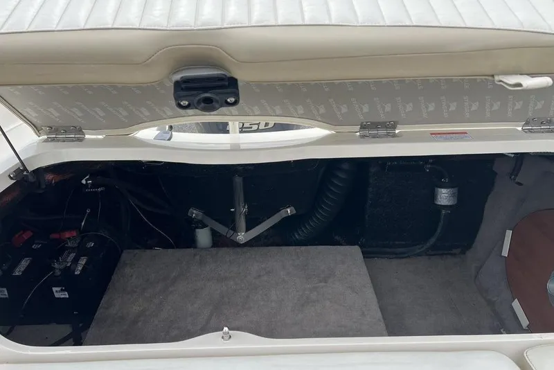 Slide: The Image of Open storage compartment of a 2015 Stingray 234LR boat, showing interior components. - 31
