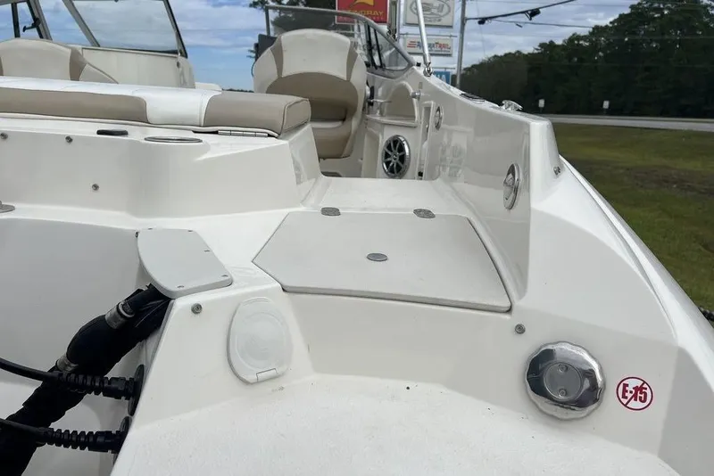 Slide: The Image of 2015 Stingray 234LR boat interior with seating and deck details. - 33