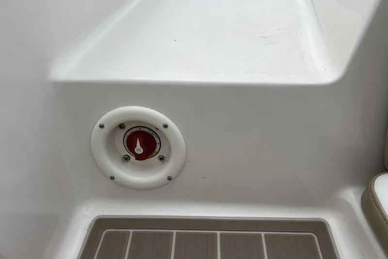Slide: The Image of 2015 Stingray 234LR boat interior with a red control dial on white panel. - 35