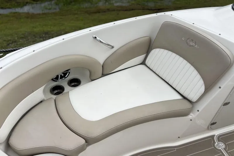 Slide: The Image of 2015 Stingray 234LR boat interior with beige and white cushioned seating. - 8