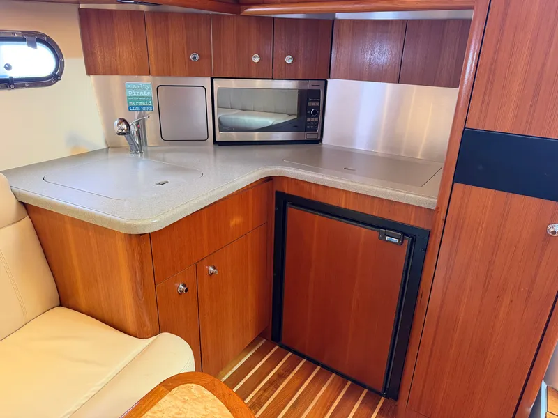 Slide: The Image of Luxurious interior of 2006 Tiara Yachts 3600 Sovran with elegant seating and wooden finishes. - 22