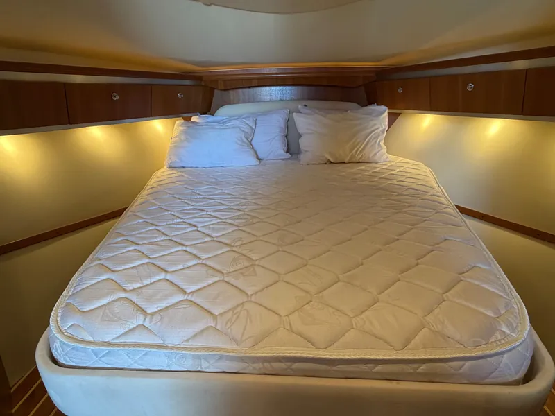 Slide: The Image of 2006 Tiara Yachts 3600 Sovran galley with wood cabinetry, microwave, and compact fridge. - 26