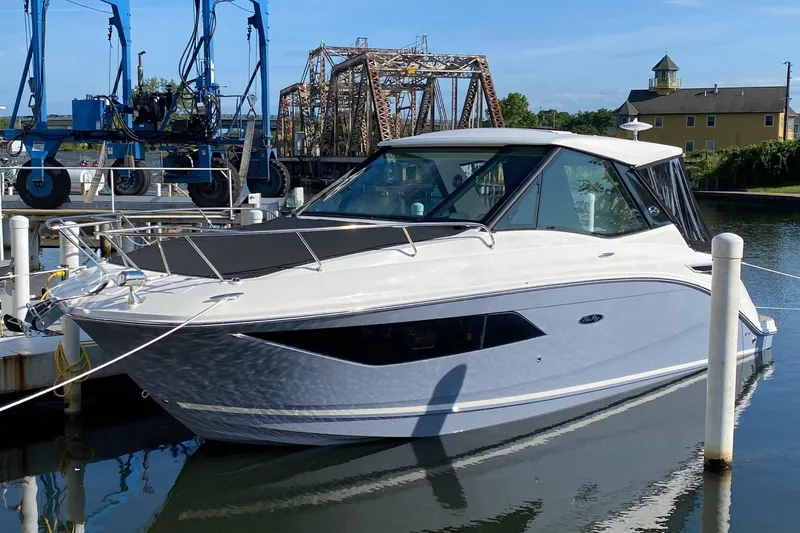 Slide: The Image of 2021 Sea Ray Sundancer 320 Coupe with teak swim platform and black cover. - 10