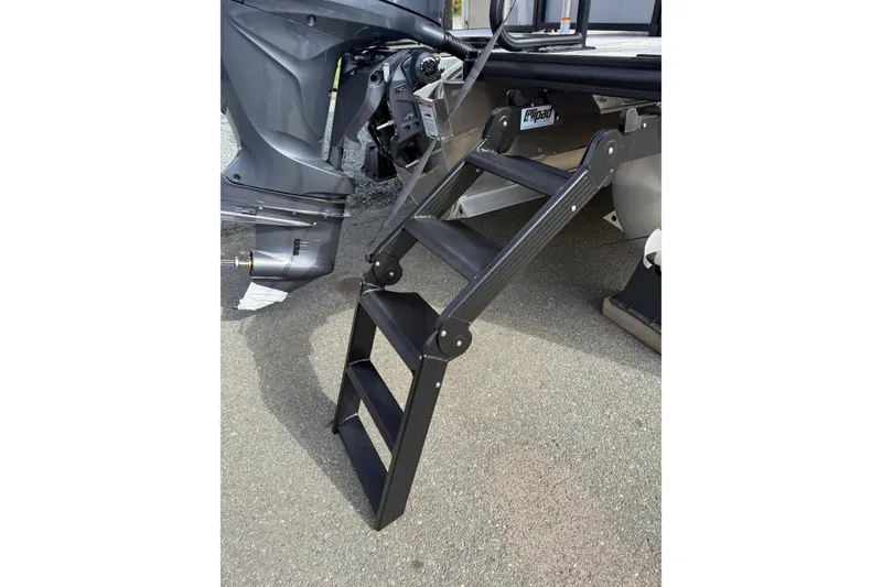 Slide: The Image of 2026 Sylvan X-3 LZ DH boat with foldable boarding ladder on pavement. - 8