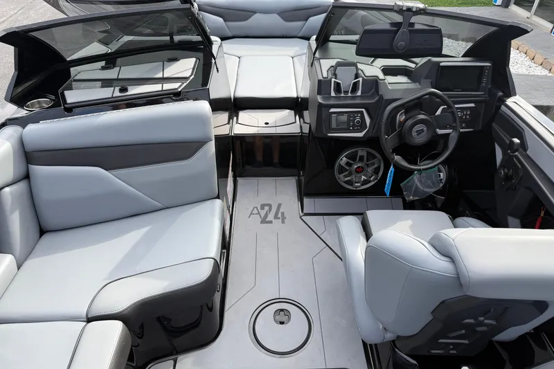 Slide: The Image of 2022 Axis A24 boat interior with modern seating and dashboard design. - 11