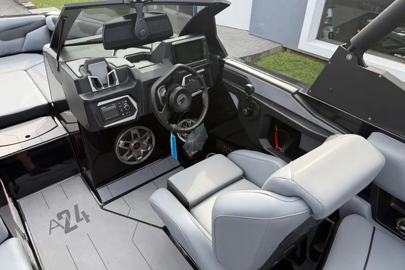Slide: The Image of 2022 Axis A24 boat interior with modern dashboard and steering wheel design. - 12