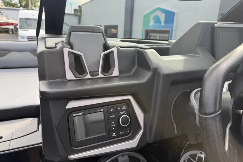 Slide: The Image of 2022 Axis A24 boat dashboard with Bluetooth stereo system and steering wheel. - 14