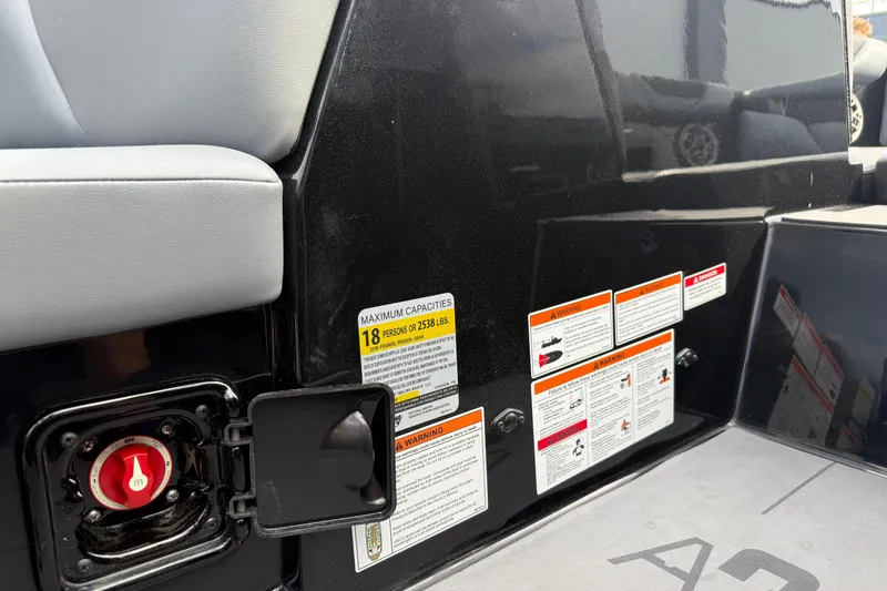 Slide: The Image of 2022 Axis A24 boat interior with capacity and safety warning labels. - 16