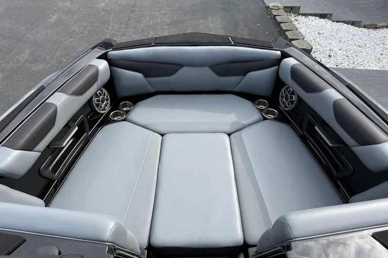 Slide: The Image of 2022 Axis A24 boat interior with gray seating and built-in speakers. - 17