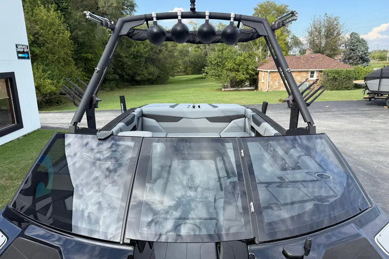 Slide: The Image of 2022 Axis A24 boat with sleek design and spacious interior, parked outdoors. - 18