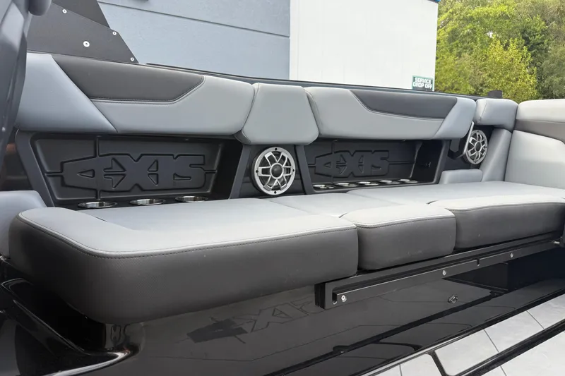 Slide: The Image of 2022 Axis A24 boat interior with gray seating and built-in speakers. - 21