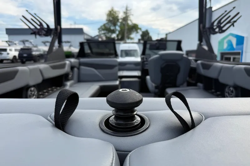 Slide: The Image of 2022 Axis A24 boat interior with seating and control knob, showcasing modern design. - 24