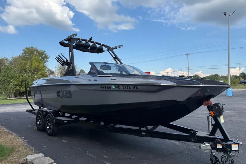 Slide: The Image of 2022 Axis A24 boat on trailer under a clear blue sky. - 3