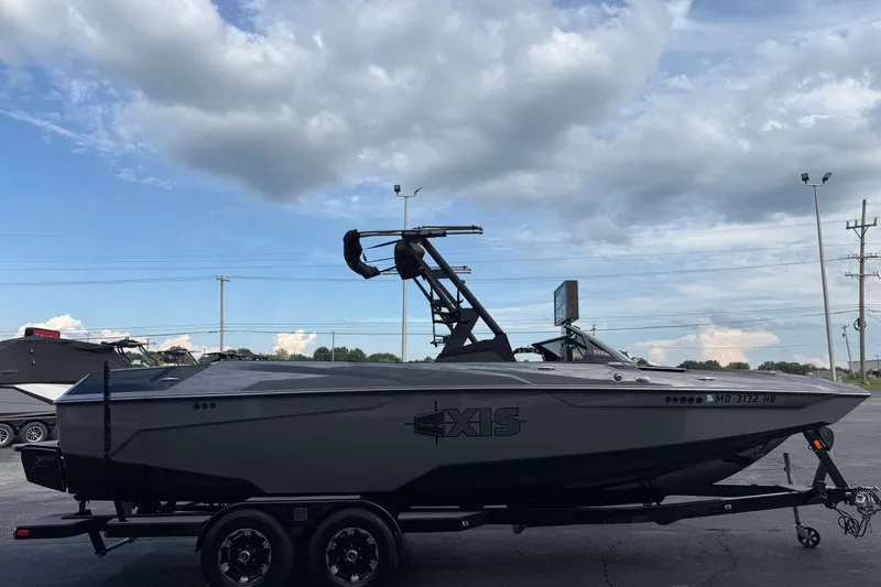 Slide: The Image of 2022 Axis A24 boat on trailer under cloudy sky. - 4