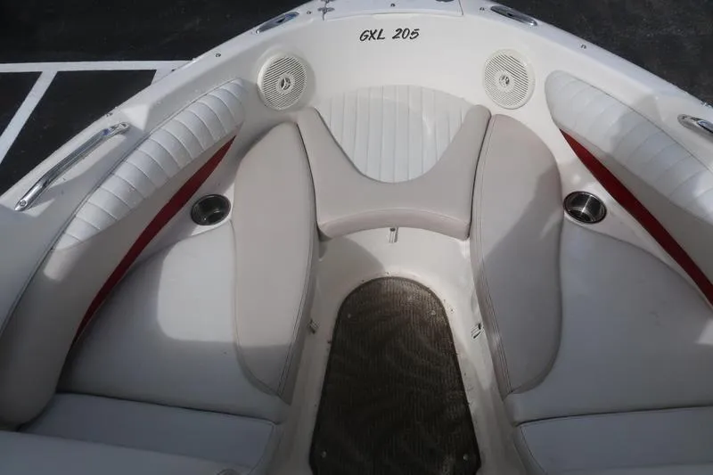 Slide: The Image of 2007 Glastron GLX 205 boat interior with white seating and cup holders. - 12