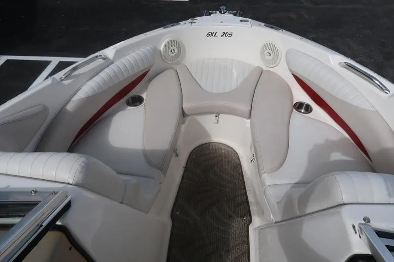 Slide: The Image of 2007 Glastron GLX 205 boat interior with white seating and cup holders. - 13