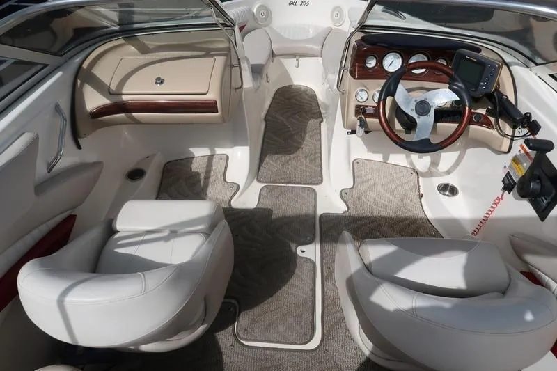 Slide: The Image of 2007 Glastron GLX 205 boat interior with white seats and modern dashboard. - 14