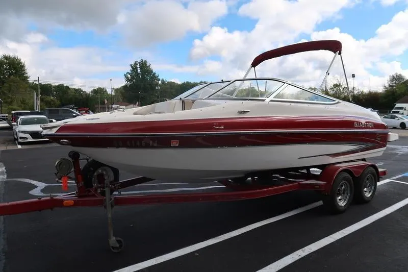 Slide: The Image of 2007 Glastron GLX 205 boat on trailer in parking lot, under cloudy sky. - 3