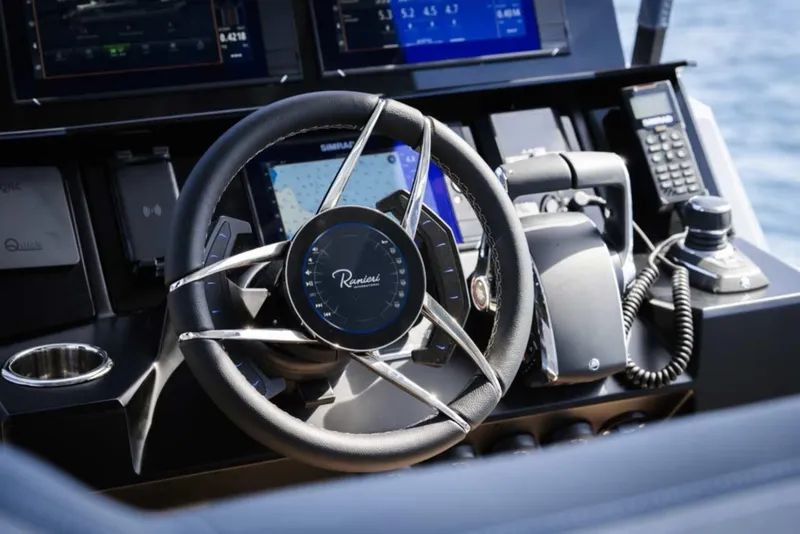 Slide: The Image of Steering wheel and controls of 2026 Ranieri CAYMAN 50 HARDTOP yacht cockpit. - 12