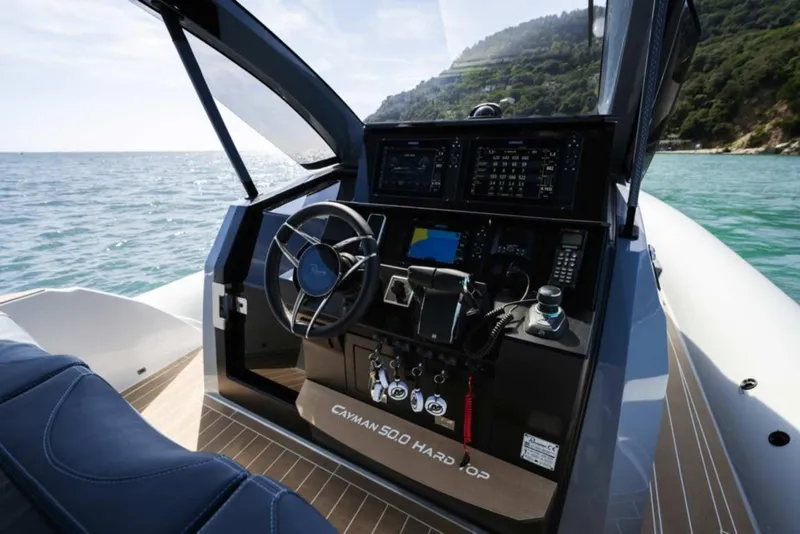 Slide: The Image of 2026 Ranieri CAYMAN 50 HARDTOP yacht cockpit with advanced navigation controls. - 13