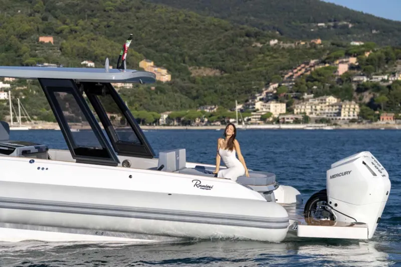 Slide: The Image of 2026 Ranieri CAYMAN 50 HARDTOP yacht on water with two people enjoying the view. - 31