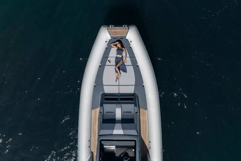 Slide: The Image of 2026 Ranieri CAYMAN 50 HARDTOP yacht with person sunbathing on deck, aerial view. - 4