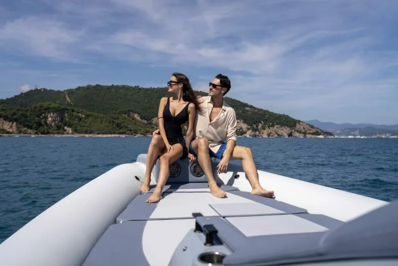 Slide: The Image of Couple relaxing on 2026 Ranieri CAYMAN 50 HARDTOP boat, scenic coastal backdrop. - 6