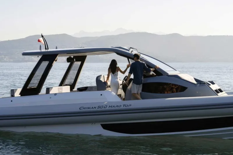 Slide: The Image of 2026 Ranieri CAYMAN 50 HARDTOP yacht cruising on serene waters with scenic mountain backdrop. - 8