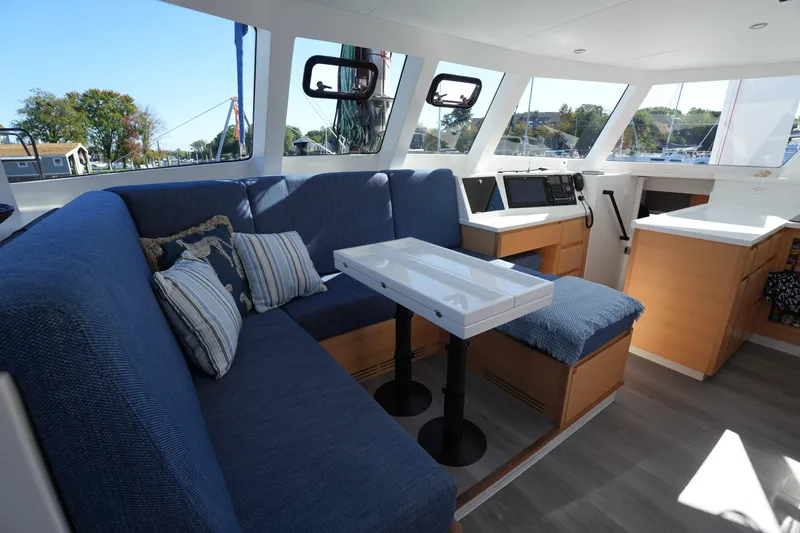 Slide: The Image of Interior of 2024 Balance 442 yacht with blue seating and modern navigation equipment. - 2