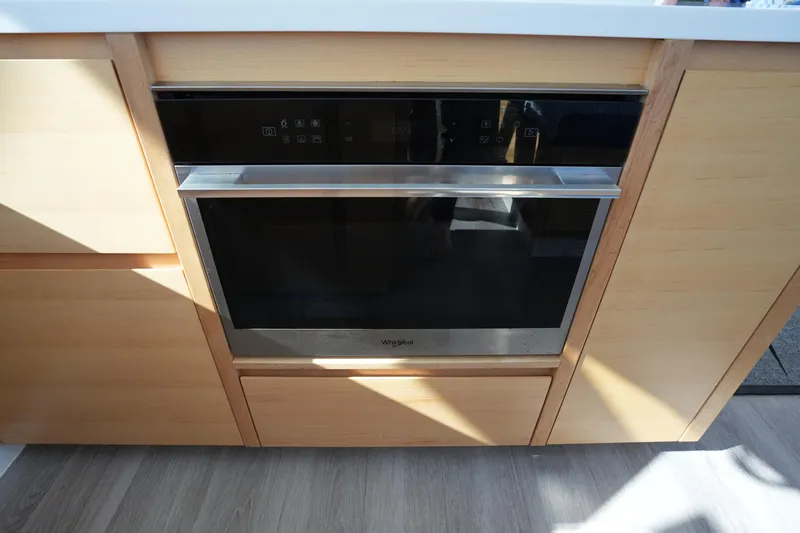 Slide: The Image of Modern kitchen oven with sleek design, integrated into wooden cabinetry, Balance 442 model, 2024. - 8