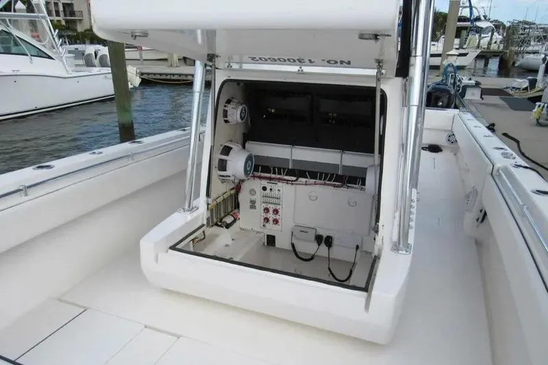Slide: The Image of 2019 Contender 39 ST boat with open console showing electrical components at marina. - 10