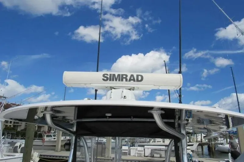 Slide: The Image of 2019 Contender 39 ST boat with Simrad radar, clear blue sky background. - 12
