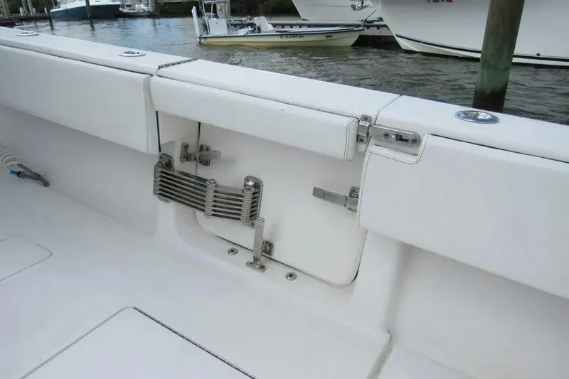 Slide: The Image of 2019 Contender 39 ST boat interior with white seating and stainless steel hardware. - 19