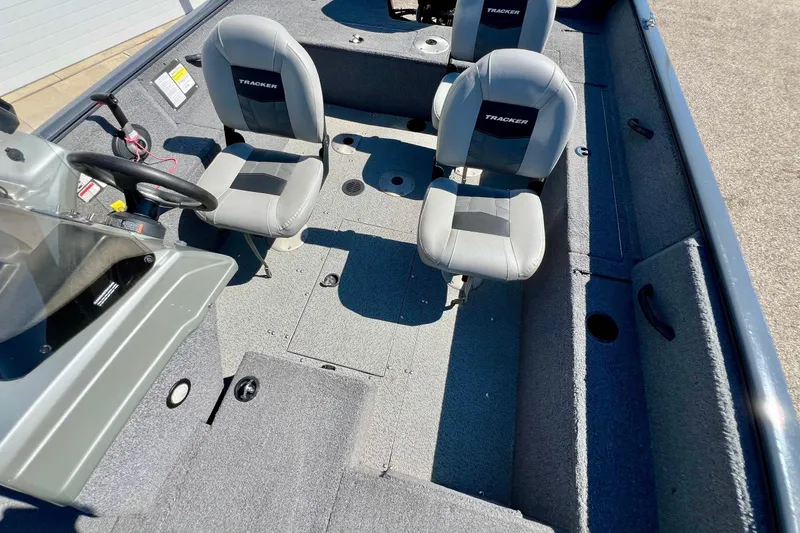 Slide: The Image of 2017 Tracker Pro Guide V-17 SC boat interior with two seats and steering console. - 18