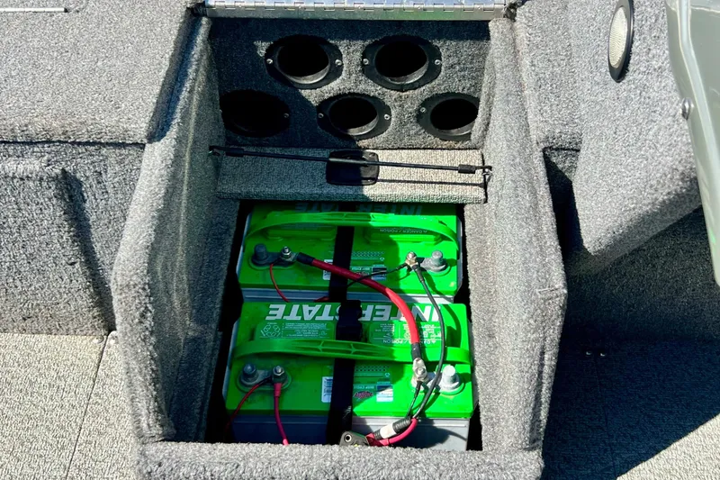 Slide: The Image of 2017 Tracker Pro Guide V-17 SC boat battery compartment with green batteries. - 19