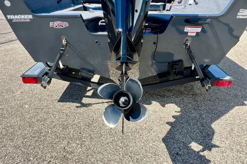 Slide: The Image of 2017 Tracker Pro Guide V-17 SC boat's rear view with propeller and trailer. - 23