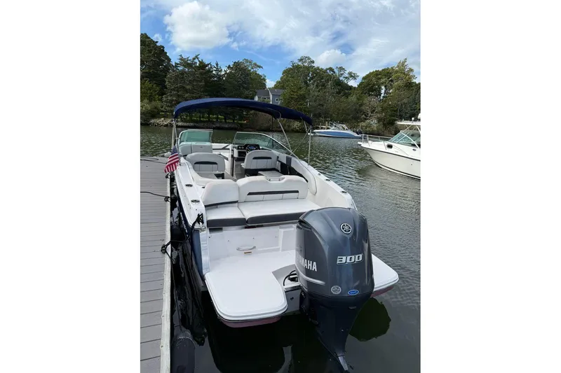 Slide: The Image of 2017 Regal 26 OBX boat with Yamaha 300 engine docked on a serene lake. - 10