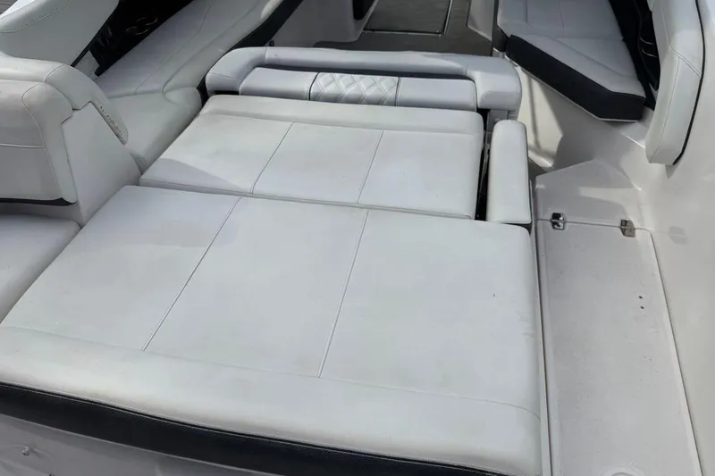 Slide: The Image of 2017 Regal 26 OBX boat interior with white cushioned seating. - 14