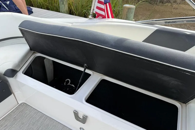 Slide: The Image of 2017 Regal 26 OBX boat with open storage compartment and American flag in background. - 18