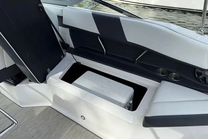 Slide: The Image of 2017 Regal 26 OBX boat interior with open storage compartment and seating. - 20