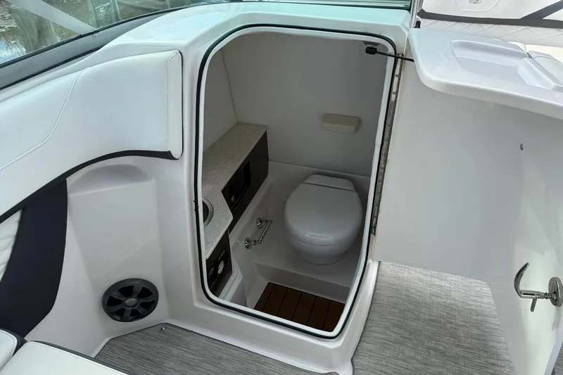 Slide: The Image of 2017 Regal 26 OBX boat interior with compact bathroom and modern amenities. - 21