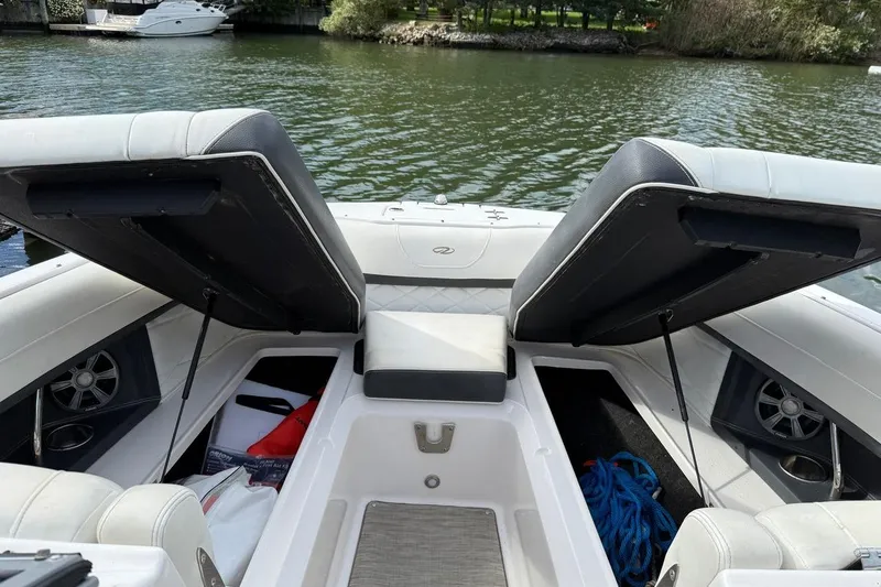 Slide: The Image of 2017 Regal 26 OBX boat interior with open storage compartments by the water. - 25