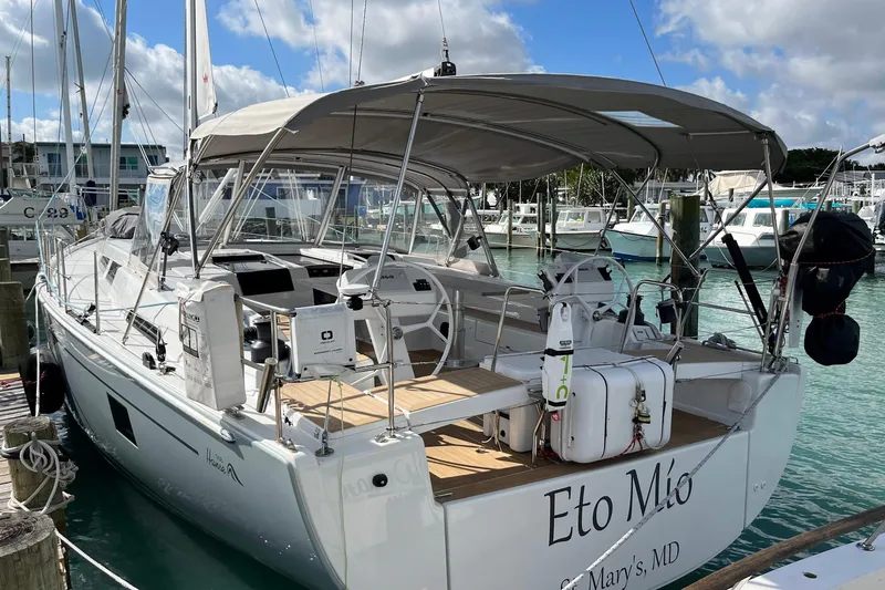 Slide: The Image of Hanse 508 yacht, 2021 model, docked in a marina with clear blue water. - 0