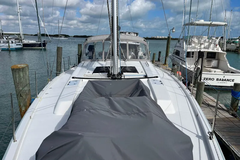 Slide: The Image of 2021 Hanse 508 yacht docked at marina, surrounded by other boats under a cloudy sky. - 10