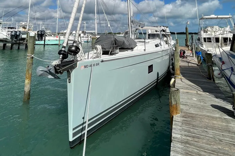 Slide: The Image of 2021 Hanse 508 yacht docked at a marina under a partly cloudy sky. - 2