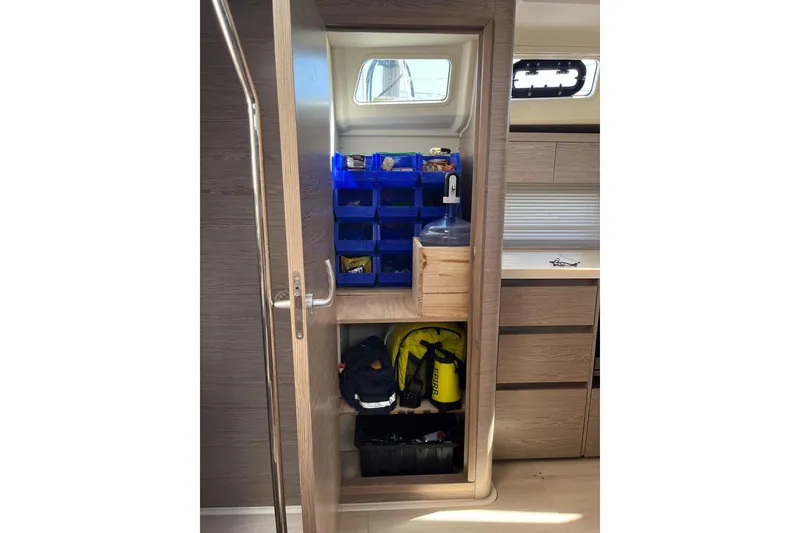 Slide: The Image of Interior storage of 2021 Hanse 508 yacht with organized shelves and equipment. - 26