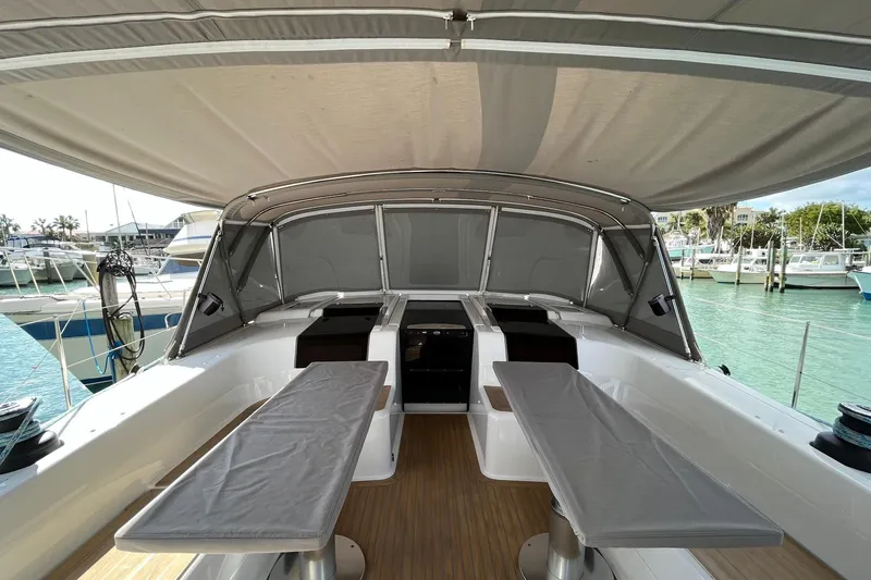 Slide: The Image of 2021 Hanse 508 yacht cockpit with covered seating, docked in a marina. - 5