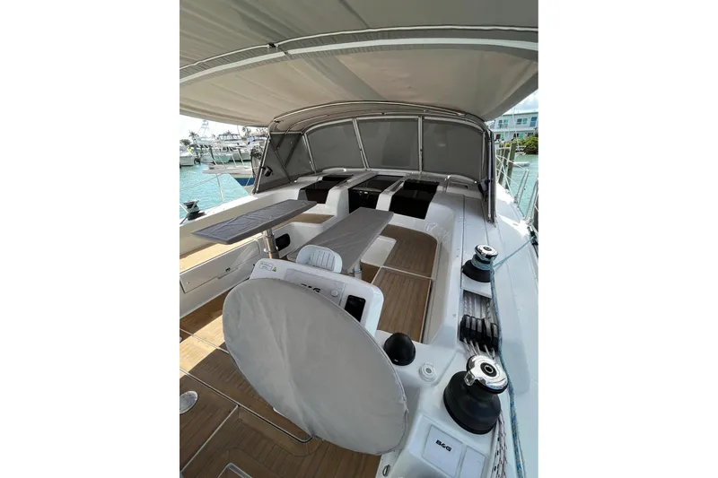 Slide: The Image of 2021 Hanse 508 yacht deck with seating and covered helm, docked at marina. - 6